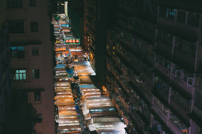 High angle view of illuminated street market amidst buildings