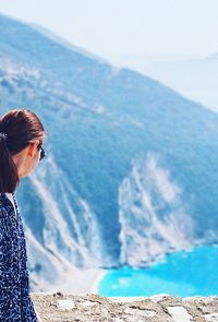 Woman standing against mountain