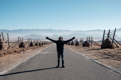 Full length of man standing on mountain against sky