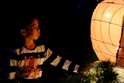 Boy looking away at night