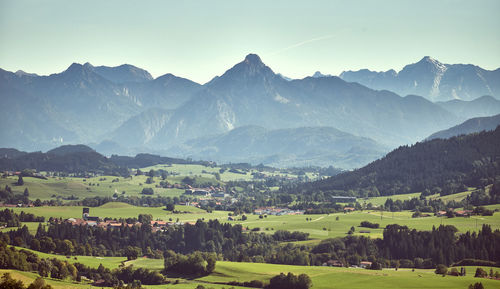 Scenic view of landscape and mountains against sky