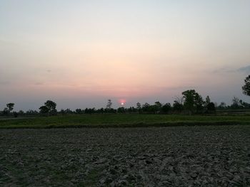 Scenic view of field against sky during sunset