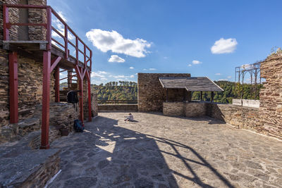 View of abandoned building against cloudy sky