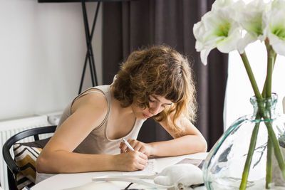 Portrait of woman sitting on table