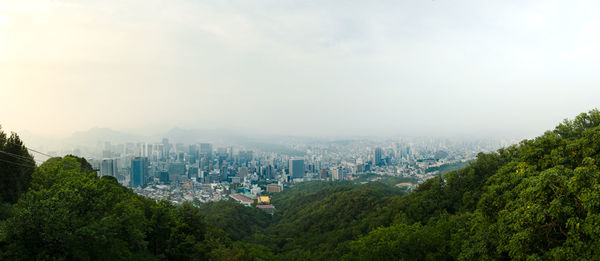 High angle view of trees and buildings against sky