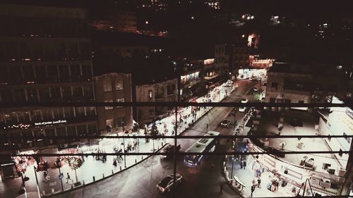 Panoramic view of people in city at night