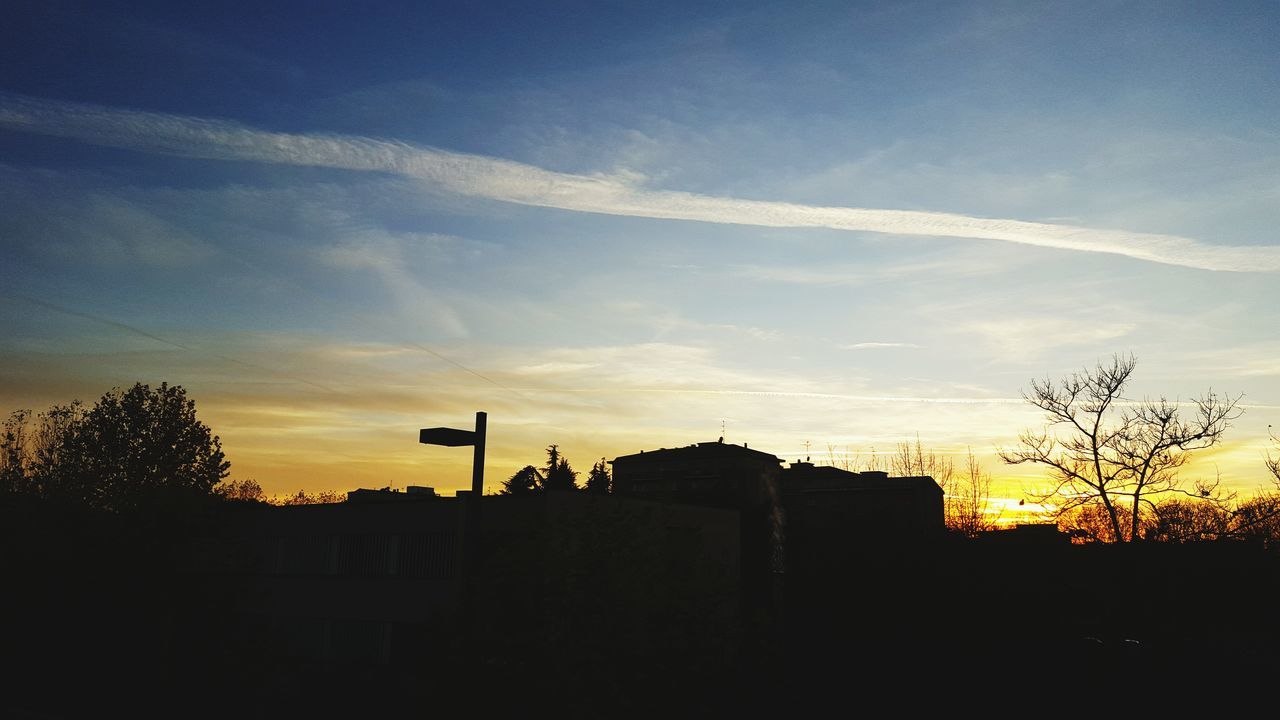 building exterior, architecture, built structure, silhouette, sunset, sky, house, tree, residential structure, cloud - sky, low angle view, cloud, orange color, beauty in nature, nature, residential building, outdoors, blue, building, no people