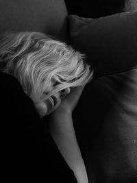 Portrait of young woman lying on bed