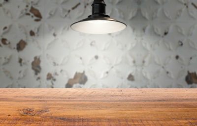 Close-up of illuminated light bulb on wall