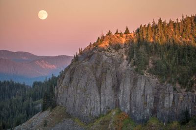 Scenic view of mountains against full moon during sunset