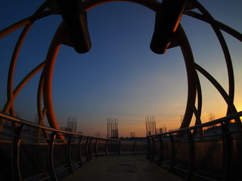 Bridge over sea against sky during sunset