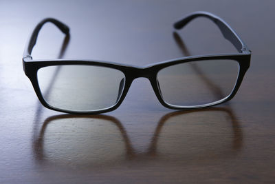 Close-up of eyeglasses on wooden table