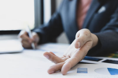 Midsection of person working on table