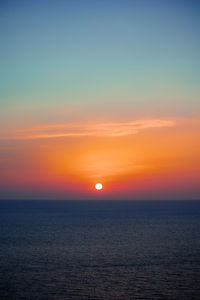 Scenic view of sea against romantic sky at sunset