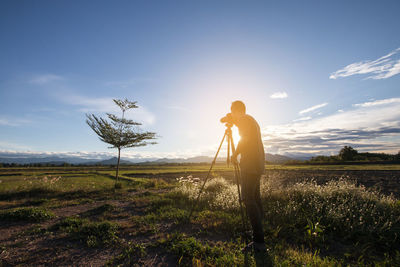 Silhouette young men travelers standing are shooting photograph