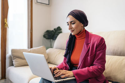 Young woman using laptop at home