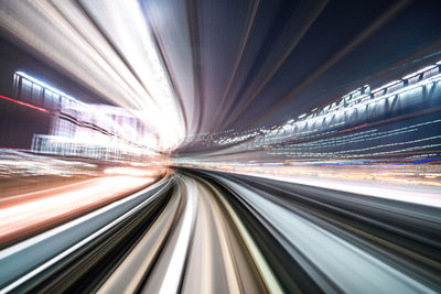 Long exposure image of illuminated road in city