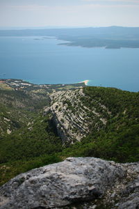 High angle view of sea and mountains against sky