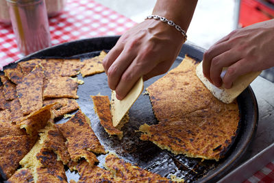 Cropped hand of person preparing food