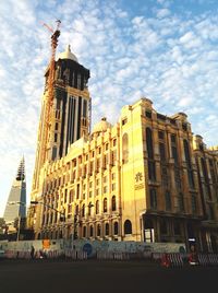 Low angle view of building against cloudy sky