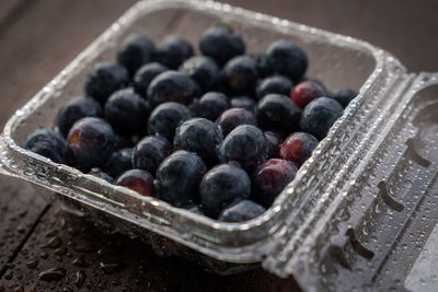 High angle view of blackberries in container on table