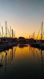 Sailboats in marina at sunset