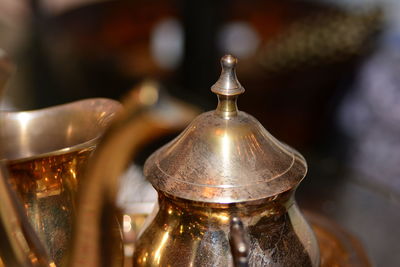 Close-up of metal containers on table