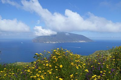 Scenic view of sea and mountains against sky