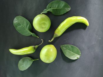 High angle view of fruits and leaves on table