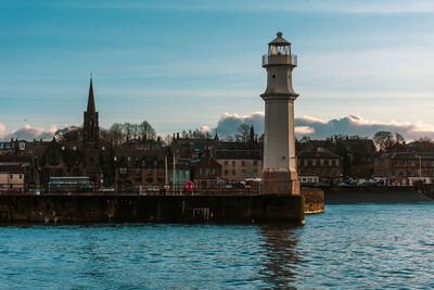 River amidst buildings against sky in city