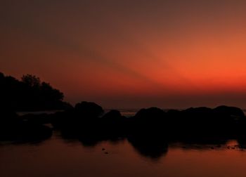 Scenic view of lake against romantic sky at sunset
