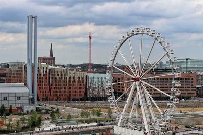 Ferris wheel in city against sky