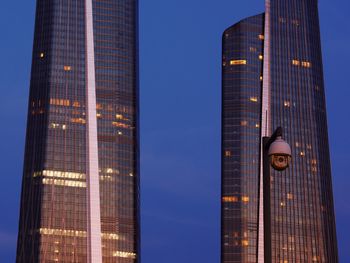 Low angle view of modern buildings against blue sky