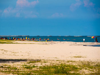 People on beach against sky