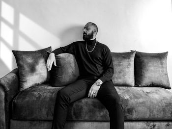 Man sitting on sofa at home