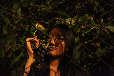 Woman holding fruit on tree