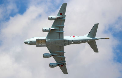 Low angle view of airplane flying against sky