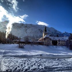 Scenic view of snow covered mountains against sky