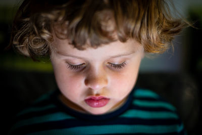 Close-up portrait of cute boy screen time