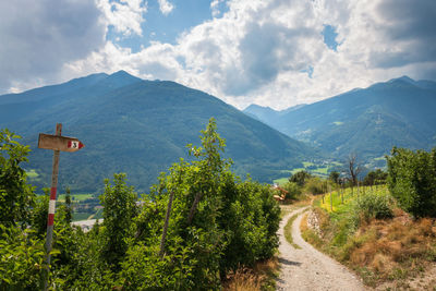 Scenic view of trail and mountains against sky