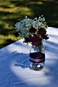 Close-up of red flower in vase on table