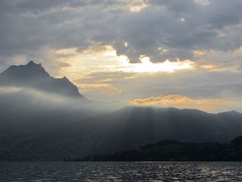 View of calm sea against mountain range