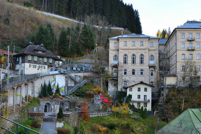 Arch bridge over river by buildings in city