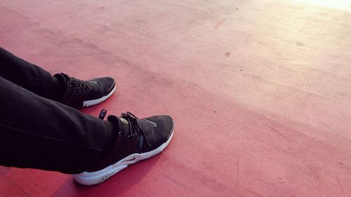 Low section of person standing on tiled floor