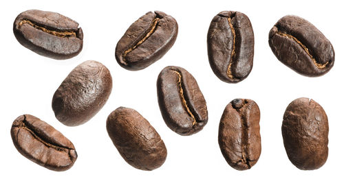 Close-up of coffee beans against white background