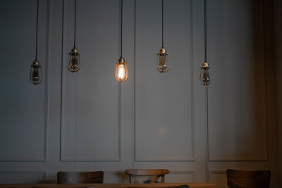Illuminated lights hanging on wall at home
