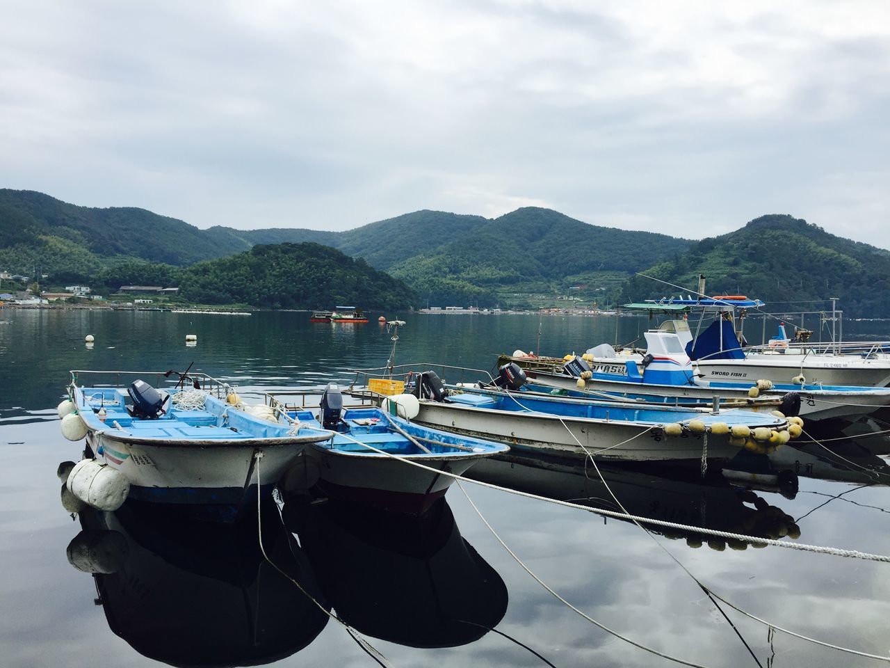 nautical vessel, transportation, boat, moored, mode of transport, water, mountain, sky, mountain range, harbor, cloud - sky, tranquil scene, mast, tranquility, lake, sea, waterfront, reflection, scenics, nature