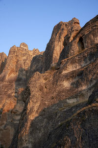 Low angle view of rock formation against clear sky