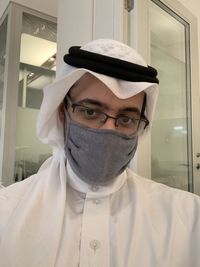 Close-up portrait of man wearing mask indoors