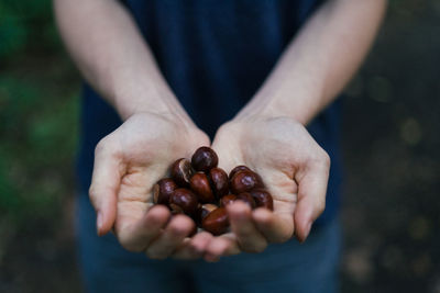 Midsection of man holding fruit